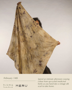 Person holding a vintage silk scarf with up-cycled medicinal herbs, featuring 'hikmarituals' and 'Meru' brands